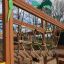 Dschungelcamp Klettergerüst mit Rutsche aus Holz und Seilnetz auf Spielplatz im Freien