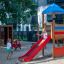 Logo Spielturm mit Vogelnestschaukel (BNS 120 cm) Kinderspielplatz mit roter Rutsche und Klettergerü