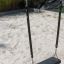 Doppelte Silbere Schaukel mit robustem schwarzem Sitz am Sandspielplatz.