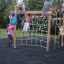 Yellowstone Klettergerüst mit Holzstruktur und Kletternetz im Spielplatz.