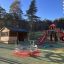 Twister Spielanlage mit Rutsche auf einem modernen Kinderspielplatz bei klarem Himmel